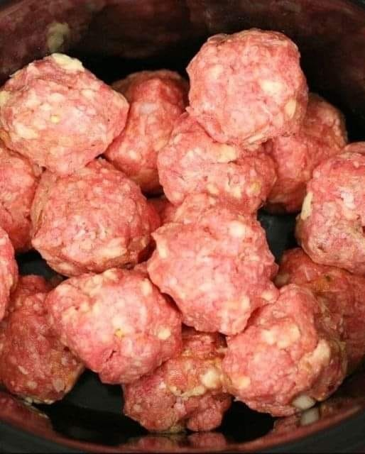 Put meatballs in a slow cooker, but the next 2 ingredients will make it special